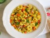 Warm salad of white meat tortellini and baked vegetables with aromatic basil oil