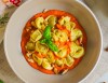 White meat tortellini with roasted bell pepper sauce and roasted almonds