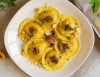 Sunflowers with sun-dried tomatoes, basil and burrata cheese in butter, anchovies and capers with taralli crumbs